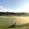 A sunny day view of a green at Eagles Nest Golf Club.