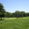 A sunny day view of two greens at White Pines Golf & Fishing.