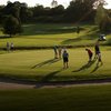 A sunny view of green protected by bunkers at Rivendell Golf Club
