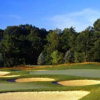 A view of a green protected by bunkers at Mystic Golf Club