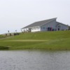 A view over the water of green #9 and clubhouse at Oshawa Airport Golf Club