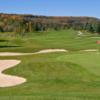A view of a green protected by a collection of sand traps at Granite Ridge Golf Club