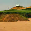 A view of a green protected by a sand trap at FireRock Golf Club