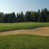 A view of a green protected by bunkers at Kingsville Golf and Country Club