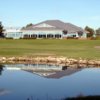 A view over the water of the practice area and the clubhouse at Carlisle Golf and Country Club