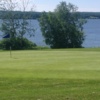 A view of a green with water in background at Beauty Bay Golf Course