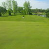 A view of a green with water on the right side at Pineland Greens Golf Club