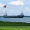 A view of hole #7 and a ship in the distance at Morrisburg Golf Club